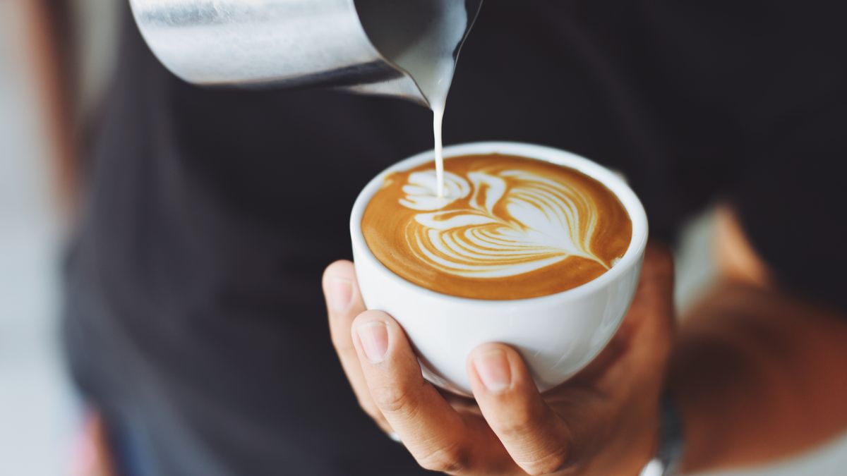 Person planning the day with coffee and a notebook